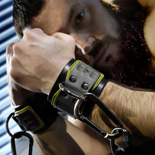 Tactical Wrist Cuff worn by a bearded model, black neoprene cuff with D-ring and carabiner, Fort Troff