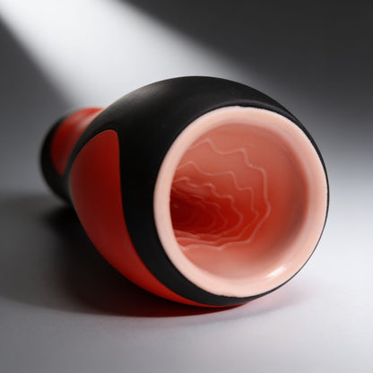 close-up view of the Vibra Head Bionic Auto Stroker showing the soft entry opening and textured internal sleeve designed for stimulating sensations