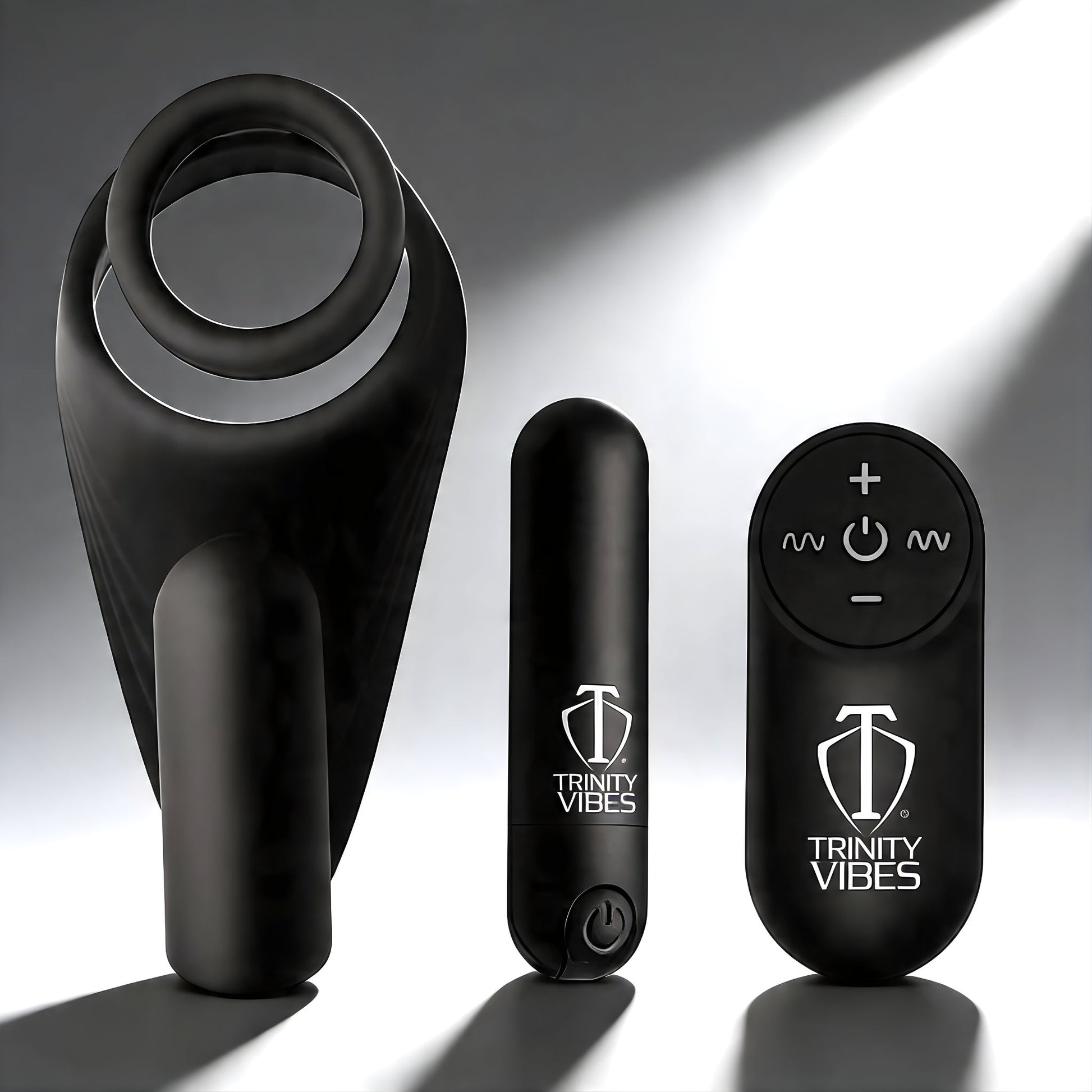 black silicone c-ring with vibrating taint stimulator alongside bullet vibrator and remote control